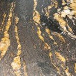 Détail de plan de travail en granit noir et doré pour cuisine sur-mesure à Annecy 74